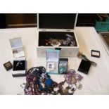 A jewellery box containing various costume jewelle