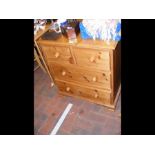 A pine chest of two short and two long drawers - w