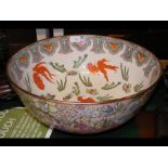 A large Chinese bowl with fish and flower decorati