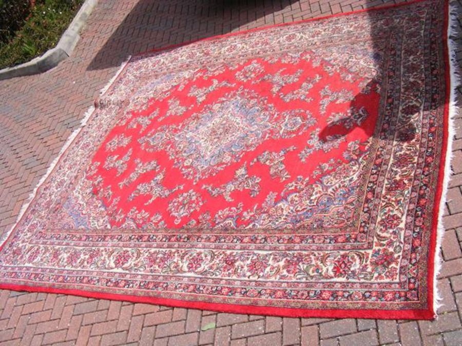 A Middle Eastern carpet with floral decoration - a