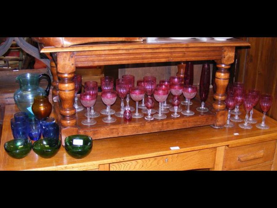 A collection of coloured glassware including cranb