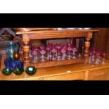 A collection of coloured glassware including cranb