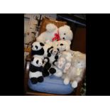A collection of soft toys, mostly pandas