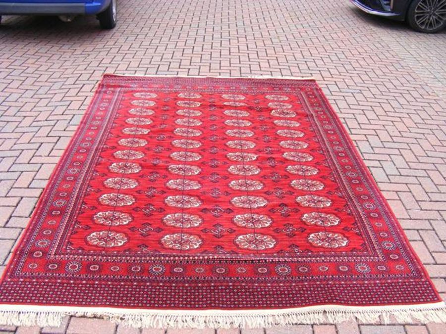 A Middle Eastern style carpet with red ground - 9f