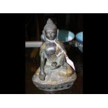 A 16cm high bronze buddha with gilt decoration