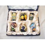 A set of six boxed miniature Moorcroft vases