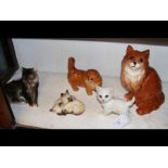 Four Beswick figures of cats, together with one ot