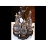 A Georgina five piece cruet on wooden and silver h