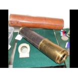 A three draw telescope in leather carrying case