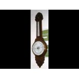 An oak framed banjo shaped barometer and thermomet