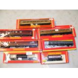 Four boxed Hornby coaches - two in maroon livery,