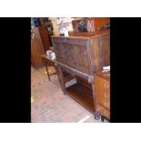 A 19th century carved oak sideboard with drop flap