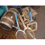 Assorted vintage tennis rackets, a beer keg and a