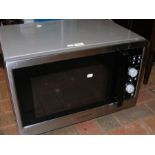 A Daewoo microwave oven in silvered finish
