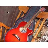 An Onyx acoustic guitar in red, together with carrying case