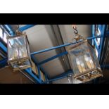 A pair of four light brass framed hall lanterns