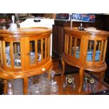 A pair of oval display cabinets/occasional tables