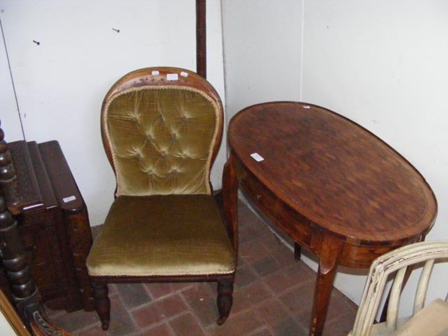 An oval occasional table, together with a nursing