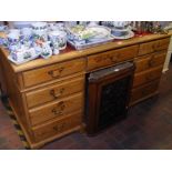 A pine pedestal desk with inset red leather top -