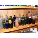 A shelf containing various antique chemist bottles