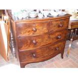 An antique bow front chest of two short and two lon