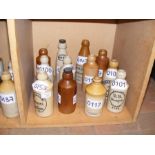 Twelve vintage Isle of Wight stoneware bottles inc