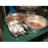 Two silver plated wine coasters together with a sa