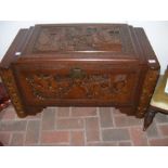 A carved camphorwood blanket chest