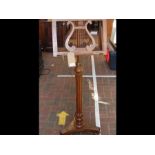 An early 19th century rosewood music stand with ly
