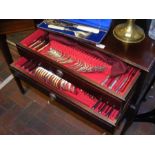 An extensive canteen of cutlery in fitted cabinet