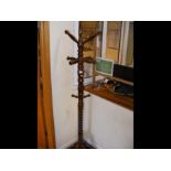 A reproduction hall tree hat and coat stand