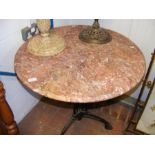 A marble top and wrought iron garden table