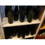 Two shelves of old Isle of Wight bottles including