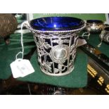 A pierced silver sugar bowl with blue glass liner