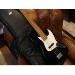 An Aria STB Series bass guitar in black, together