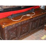 A period oak panelled coffer with carved front - 1