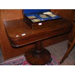 A Victorian mahogany fold-over games table
