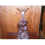 A carved wooden epergne with trumpet glass vase