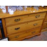 An antique pine chest of three long drawers