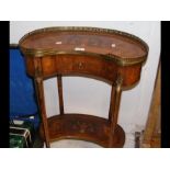 A small kidney shaped two tier occasional table wi