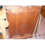 A two door panelled pine cupboard