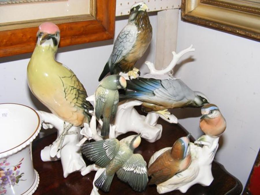 Four continental ceramic bird ornaments