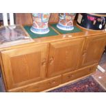 An Ercol Golden Dawn three door sideboard with two