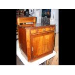 An early 19th century inlaid mahogany cabinet with