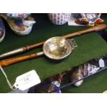 A silver toddy ladle together with strainer