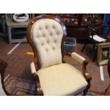 A Victorian armchair with button back and turned f