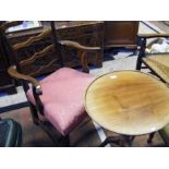 An antique armchair together with a tripod table