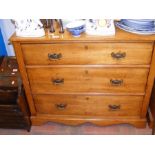 An antique chest of three long drawers