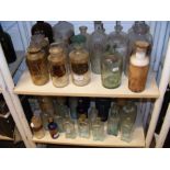 Two shelves of old Isle of Wight related chemist a