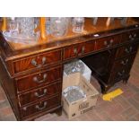 A reproduction mahogany pedestal desk with inset t